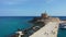 Mandraki port with deers statue, where The Colossus was standing and fort of St. Nicholas. Rhodes, Greece. Hirschkuh statue in the