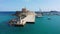 Mandraki port with deers statue, where The Colossus was standing and fort of St. Nicholas. Rhodes, Greece. Hirschkuh statue in the