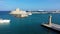 Mandraki port with deers statue, where The Colossus was standing and fort of St. Nicholas. Rhodes, Greece. Hirschkuh statue in the