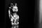 Maneki Neko, the Lucky Cat, covered with dust, black and white. Concept of fast passing time and expectation of good luck