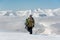 Manful snowboarder walking in the mountain resort