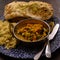 Mangalorean style roasted cauliflower and spinach curry with basmati rice and garlic naan bread, tasty vegetarian food