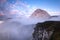 Mangart Mountains Peak above Clouds at Dramatic Sunset in Julian Alps