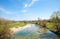 Mangfall river with bikeway and small village beside, upper bavarian landscape in spring