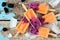 Mango blackberry ice pops, top view scene over rustic wood