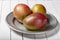 Mango fresh fruit on white wooden table