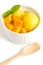 Mango icecream in a white bowl on white background.