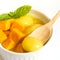 Mango icecream in a white bowl on white background.