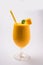 Mango Lassi or smoothie in big glass with mint leaf. Side angle Isolated over colourful background