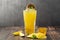 Mango lemonade with bubble tea on dark wooden background