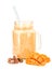 Mango milkshake in mason jar with blue and white drinking straw decorated with mango halves and chocolate pieces isolated on white