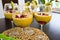 Mango mousse in wine glasses with kiwi and pomegranate seeds