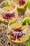 Mango mousse in wine glasses with kiwi and pomegranate seeds