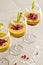 Mango mousse in wine glasses with kiwi and pomegranate seeds