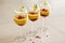 Mango mousse in wine glasses with kiwi and pomegranate seeds