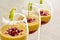 Mango mousse in wine glasses with kiwi and pomegranate seeds