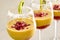 Mango mousse in wine glasses with kiwi and pomegranate seeds