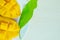 Mango nicely cut with leaf on wooden background (Also known as h