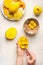 Mango preparation step by step. Female hands girl take mango cubes from the peel with a spoon on white background with fruits