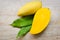 Mango slice and mango leaves from tree tropical summer fruit concept - Sweet ripe mangos cut half