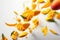 Mango Slices Flying On White Background, Floating In The Air. Generative AI