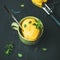 Mango sorbet ice cream scoops with mint, square crop