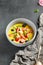 Mango soup with fresh berries and fruits. Asian dessert food on dark slate background. Chinese, asian, authentic food concept