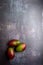 mangoes, cut and uncut, on a black, dark, metallic, cement, marble, stone background