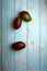 mangoes, cut and uncut, on a light blue background of deteriorated wood