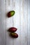 mangoes, cut and uncut, on a light white background of deteriorated wood