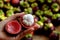 Mangosteen cut in half in woman hand on mangostana garcinia background