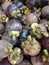 mangosteen fruit, white filling, 4 or 5 seeds, brown skin.