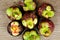 Mangosteen, group of Mangosteens on wooden table