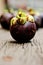 Mangosteen, group of Mangosteens on wooden table