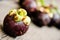 Mangosteen, group of Mangosteens on wooden table