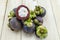 Mangosteen summer fruit closeup of the queen of fruits on wood background