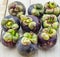 Mangosteen summer fruit closeup of the queen of fruits on wood background