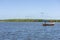 Mangue Seco, Bahia, Brazil - July 02, 2016: Fishermen on boat at work in the beach of Mangue Seco Beach