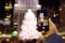 Manhattan, New York, USA - December 25, 2019: Person take shot on smartphone famous huge live Christmas tree near Rockefeller