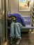 Manhattan, NY US - February 26, 2018 Homeless person sleeps in a subway car