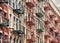 Manhattan old residential buildings with fire escapes, New York