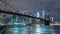 Manhattan skyline and Brooklyn bridge at night. Timelapse. Tall buildings on background, New York, NYC