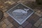 Manhole cover art in Nagasaki with a whale and the dutch word Walvis