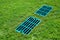 Manhole drainage grates on the lawn with green grass septic tank cover.