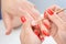 Manicure applying - cleaning the cuticles