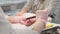 Manicure care procedure. Closeup view of beautician\'s hand filing nails of woman in salon