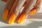 Manicure closeup. Woman orange nails close-up. Nail care in beauty salon. Spa healthy treatments for female hands. Fashion bright