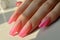 Manicure closeup. Woman pink nails close-up. Nail care in beauty salon. Spa healthy treatments for female hands. Fashion bright