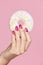 Manicure. Hand With Pink Nails Holding Donut