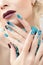 Manicure and makeup with turquoise stones.